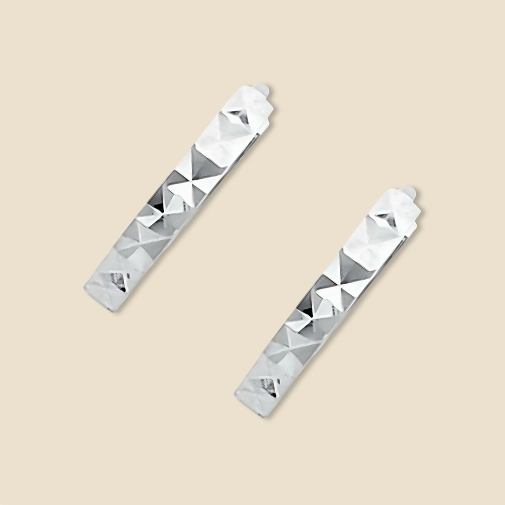A pair of 14K white Gold Huggies earrings against a plain backdrop, clearly showing the 11mm round shape and diamond-cut design.