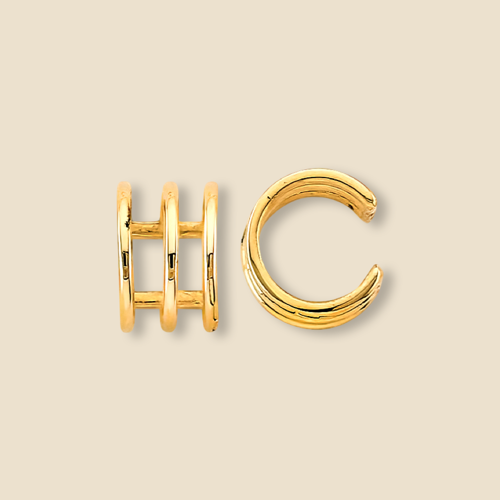 Triple line 14K yellow gold ear cuff shown on a plain background, showcasing its sleek and minimalist structure.