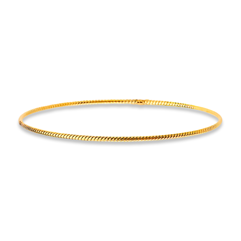 A minimalist 14K yellow gold braided bangle lying flat on a solid white background. Its fine 1.5mm width and cool-toned polished finish offer a sleek, modern look, enhanced by the subtle texture of the braided detailing.
