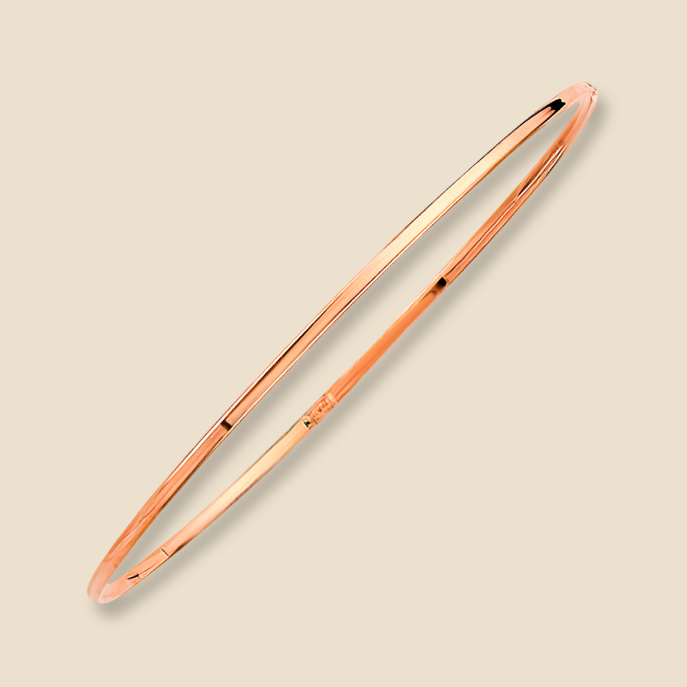 A 14K rose gold plain bangle bracelet with a slim 1.5mm width shown on a plain background, reflecting light off its polished gold surface.
