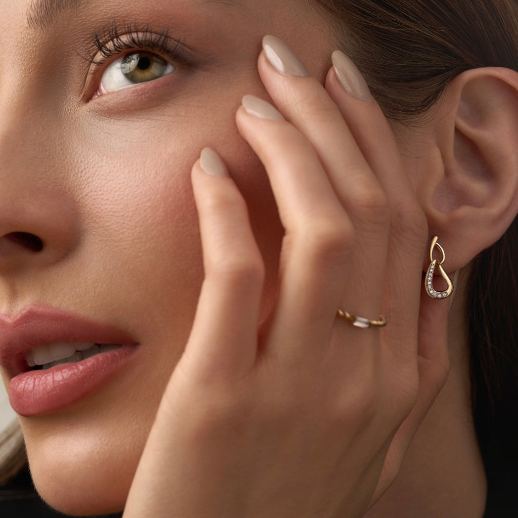 Model wearing 14K yellow gold CZ stud earrings, showcasing their delicate sparkle and timeless elegance for everyday wear.