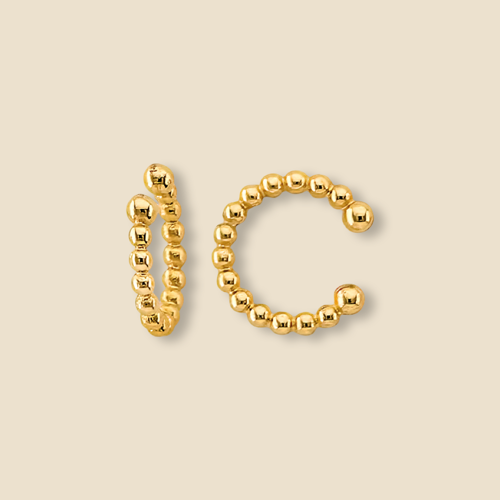 Beaded 14K yellow gold ear cuff shown on a plain background with polished finish and no piercing design.