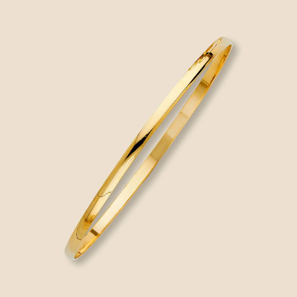 Solid gold pendant against a plain background, emphasizing its simplicity and shine.