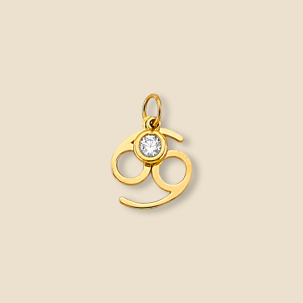 14K yellow gold Cancer zodiac pendant with sparkling cubic zirconia accent, displayed on a plain background to highlight its polished shine.