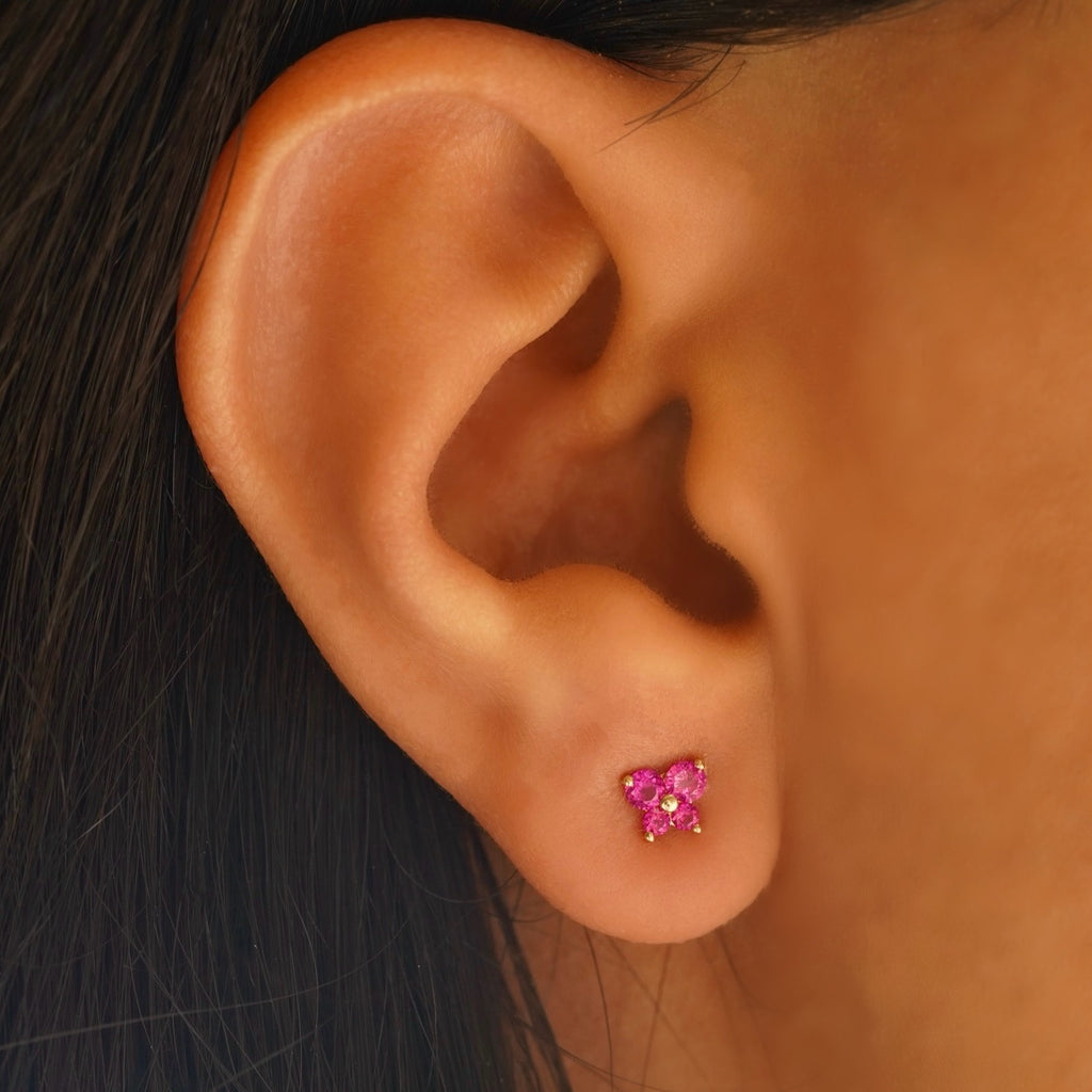 Model wearing 14K yellow gold butterfly earrings with cubic zirconia, highlighting their dainty and elegant fit.