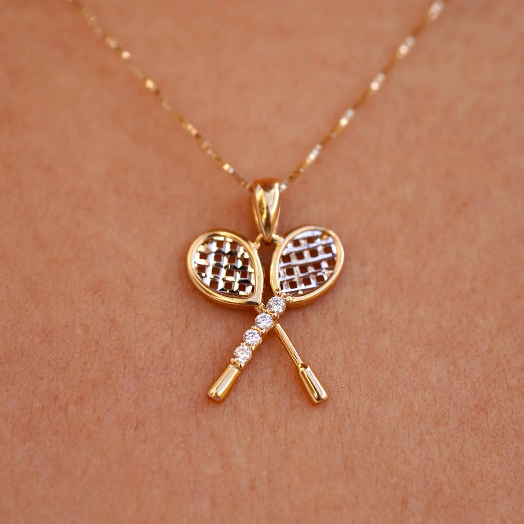 Close-up of a model wearing the 14K Gold Tennis Racquet Pendant, showcasing its elegant design and sparkling cubic zirconia stones.