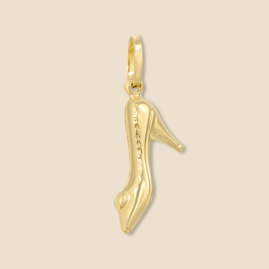 Isolated image of a 14K yellow gold high heel shoe charm pendant displayed on a plain background. The high-resolution shot captures the sleek, polished finish, slender heel structure, and smooth edges of the pendant, allowing the full beauty and clean lines of this elegant gold jewelry piece to shine without distraction.