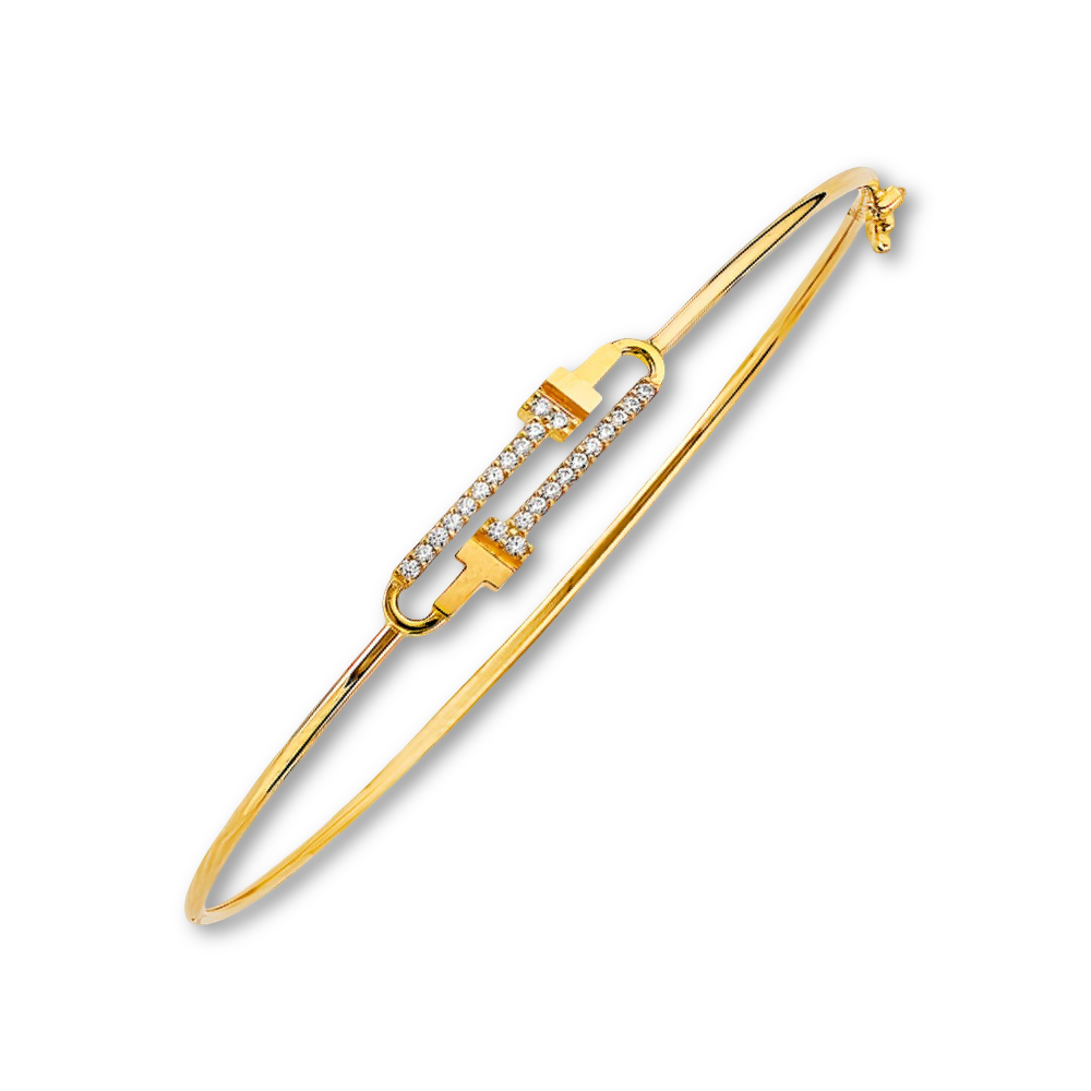 Minimalist CZ flexible bangle in 14K yellow gold placed on a plain white background, highlighting its elegant form and polished finish.