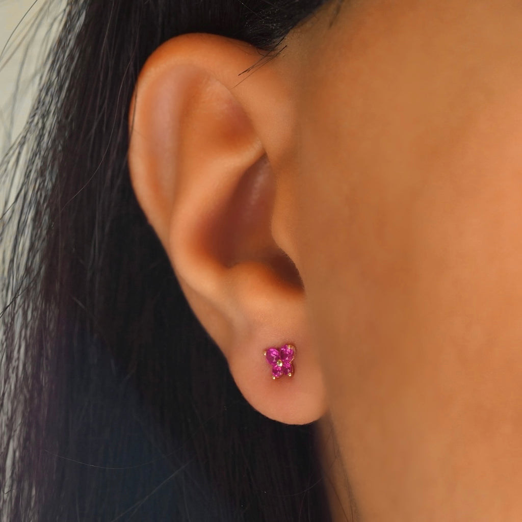 Model wearing 14K yellow gold butterfly earrings with cubic zirconia, highlighting their dainty and elegant fit.