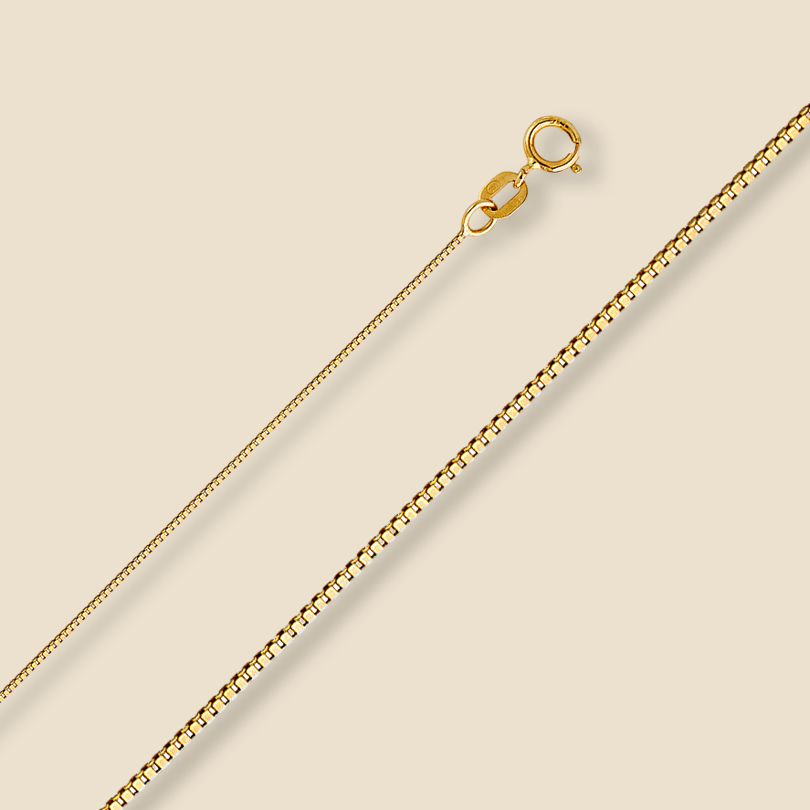14K yellow gold 0.5mm box chain necklace displayed on a plain background, highlighting its sleek, polished finish and fine craftsmanship.