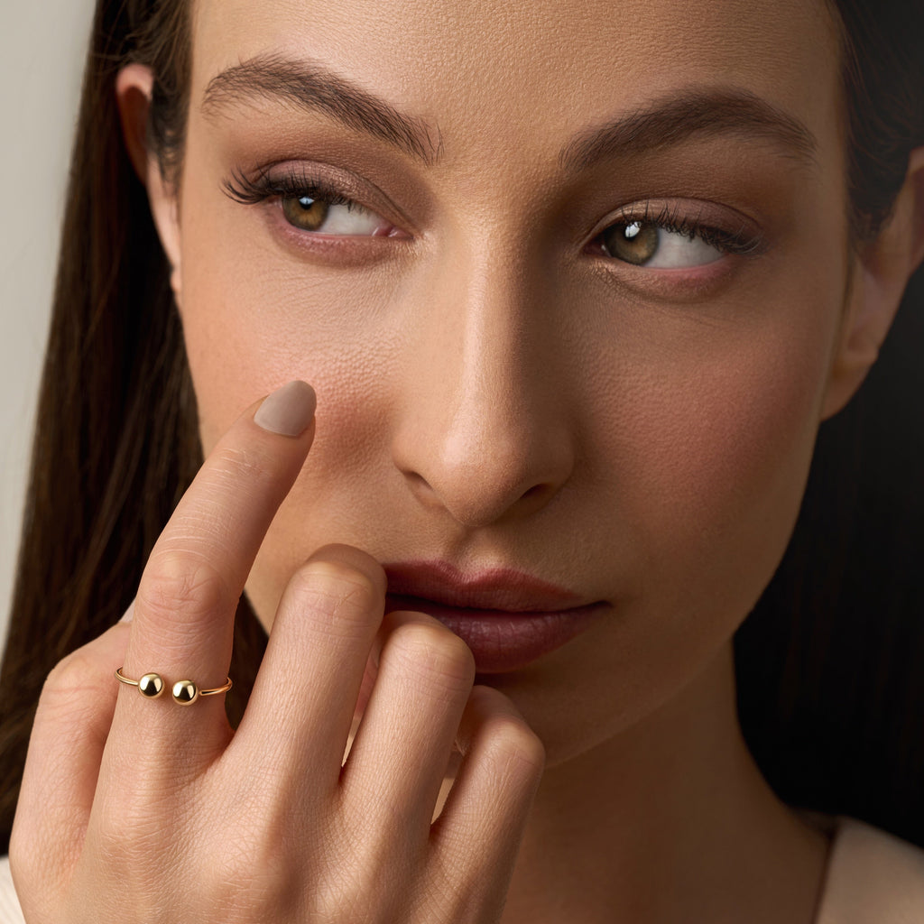 Model wearing 14K Yellow Gold Open Cuff Ball Ring, showcasing its adjustable open cuff design and subtle, modern elegance.