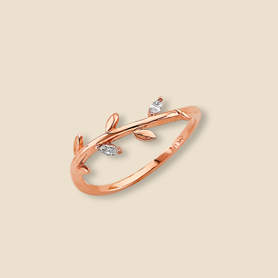 14K pink gold leaf ring with CZ stones photographed on a plain background for a minimalist display.