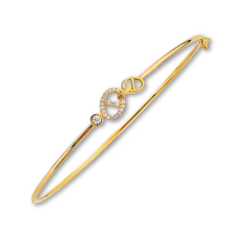 14K yellow gold CZ bangle displayed on a plain background, focusing on its elegant sparkle and slim profile.