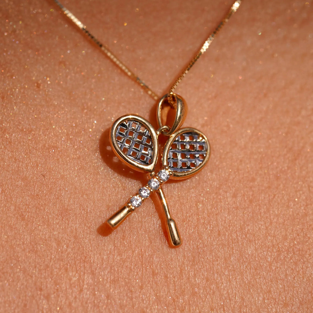 Close-up of a model wearing the 14K Gold Tennis Racquet Pendant, showcasing its elegant design and sparkling cubic zirconia stones.