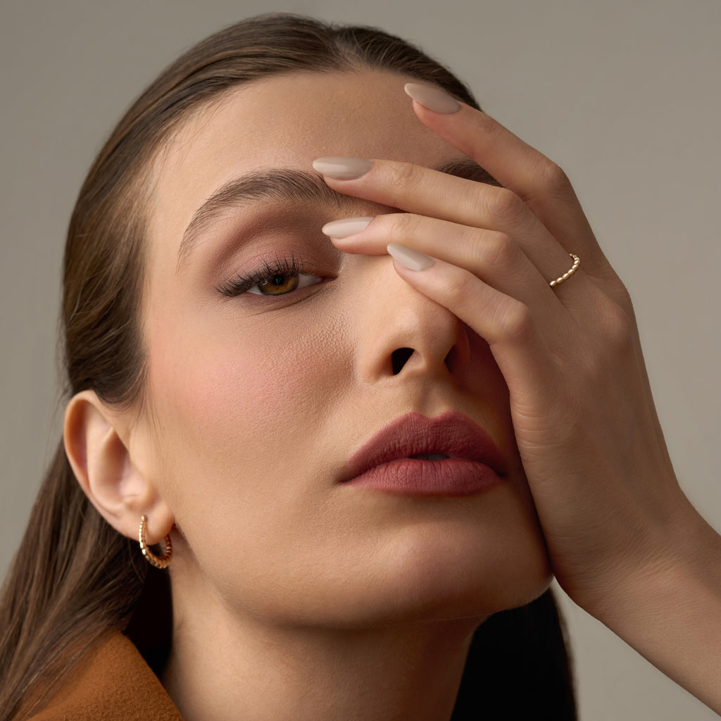 A model wearing the 14K yellow gold polish ball ring on her hand, showcasing its delicate row of polished gold beads. The ring’s minimalist and dainty design adds a subtle shine to the model’s elegant look, perfect for everyday wear or stacking with other fine gold rings
