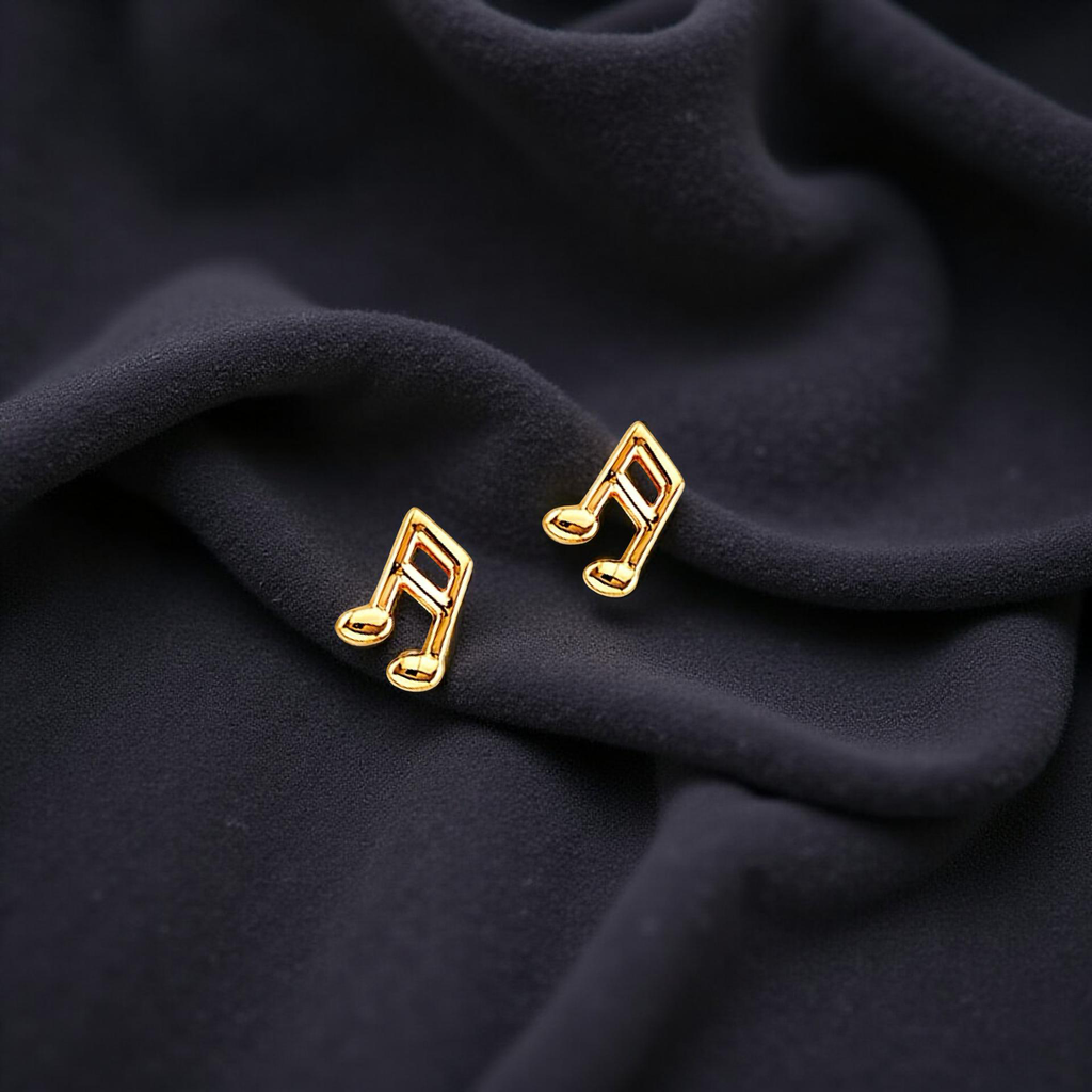 A pair of 14K yellow gold music note earrings displayed elegantly on a black velvet fabric, highlighting their polished shine and delicate design.