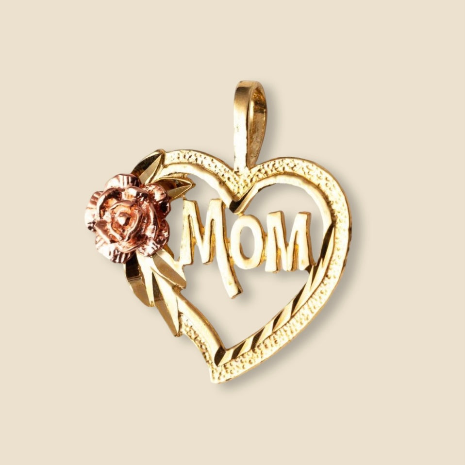 Close-up of a 14K yellow gold Mom heart pendant on a plain background, capturing the polished finish and delicate engraved design.