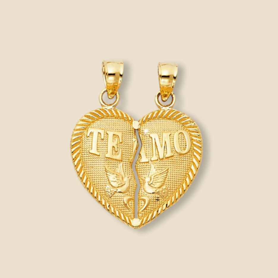 Minimalist studio shot of 14K yellow gold “Te Amo” breakable heart pendant on a plain background, highlighting polished shine and intricate detail.