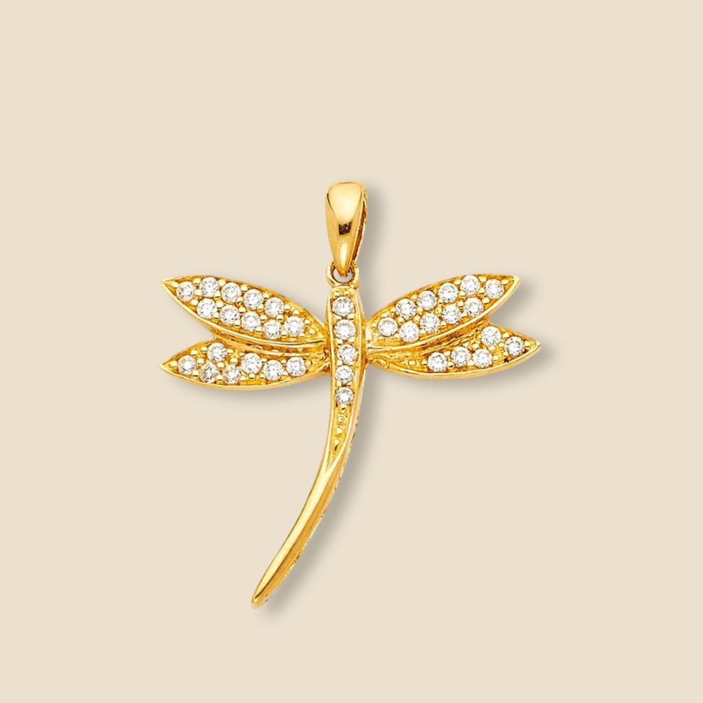 A 14K solid gold dragonfly pendant with cubic zirconia stones, displayed against a plain background. The delicate wings shimmer with sparkling stones, highlighting the pendant's elegant craftsmanship.