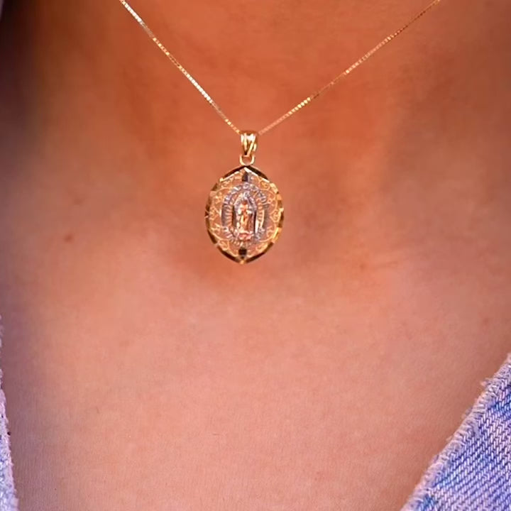 A stunning 14K Tri-Color Gold Our Lady of Guadalupe Pendant worn by a model, showcasing its elegant size and spiritual significance as a statement piece of fine religious jewelry.