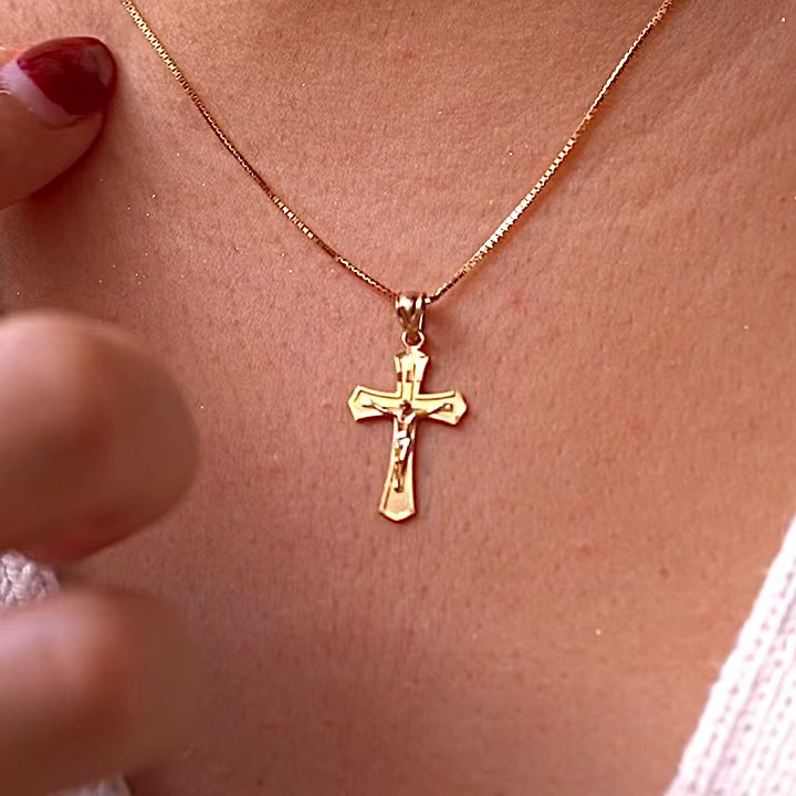 A model wearing the 14K Yellow Gold Crucifix Cross Pendant on a gold chain, highlighting its religious significance and elegant craftsmanship.