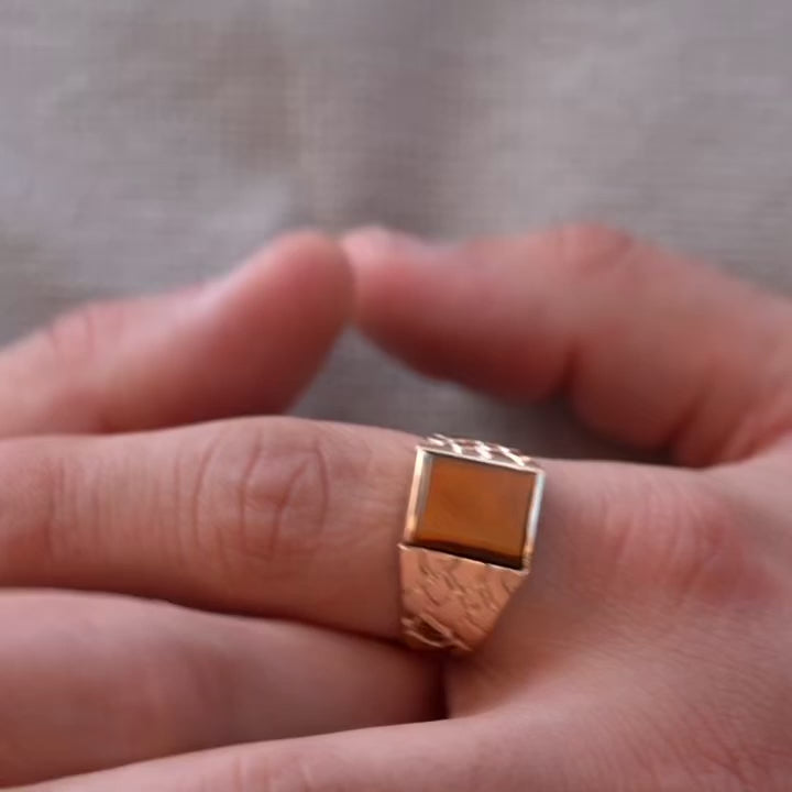 A sophisticated men's 14K gold ring with a 19mm width, worn on the hand of a model. The polished yellow gold catches the light, adding a touch of elegance and confidence to any outfit.