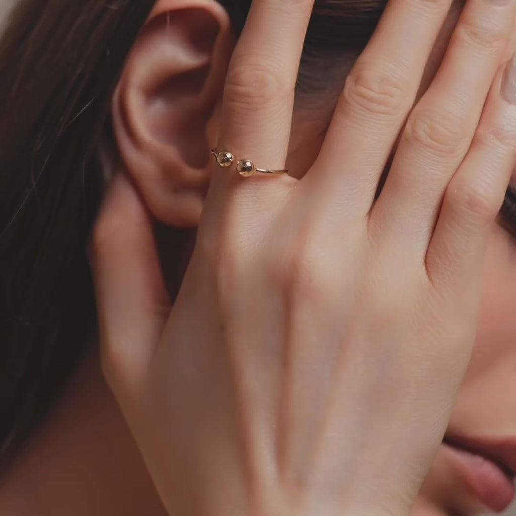 Model wearing 14K Yellow Gold Open Cuff Ball Ring, showcasing its adjustable open cuff design and subtle, modern elegance.