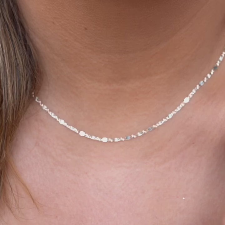A model elegantly wearing the 14K solid gold Valentino chain necklace, showcasing its refined, lightweight design. The 2mm chain drapes gracefully around the neck, highlighting its polished gold shine. Perfect for everyday wear or special occasions, this Italian-made chain exudes timeless sophistication and versatility.