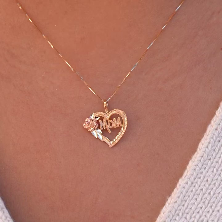 Model wearing a delicate 14K yellow gold Mom heart pendant necklace, featuring an elegant heart design with "Mom" written inside, symbolizing love and gratitude, perfect for celebrating motherhood with a timeless touch.