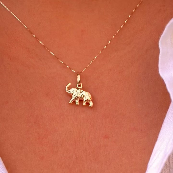 Model elegantly wears the 14K Gold Elephant Pendant on a delicate chain, highlighting its dainty size and sophisticated charm.