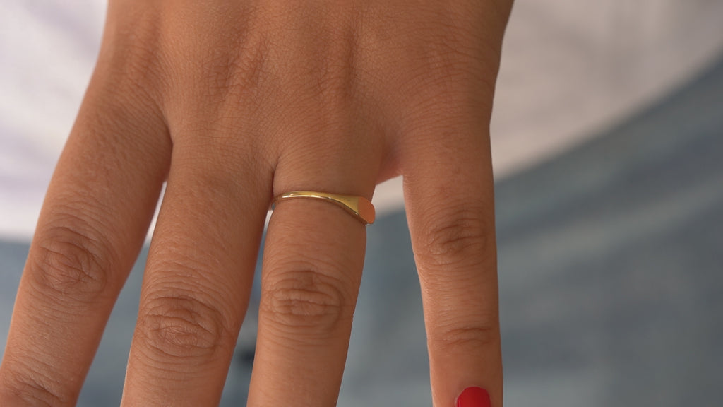 Video showcasing a 14K Solid Gold Signet Ring with a sleek, polished finish, rotating to display its classic design and smooth edges, highlighting its elegance and versatility for both men and women.