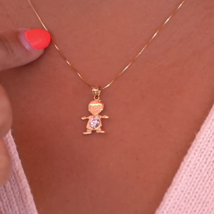 A model wearing the April boy charm on a delicate gold chain, showcasing how the dainty 14K gold pendant sits beautifully near the collarbone, with the white birthstone catching light elegantly.