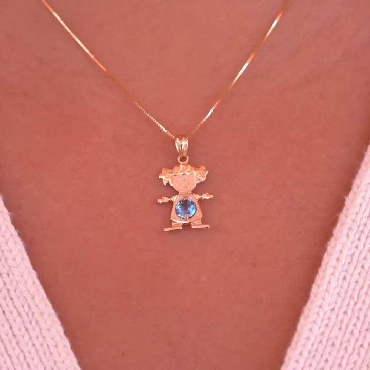 A model wearing 14K solid gold girl charm pendant with March light blue birthstone on a necklace chain.