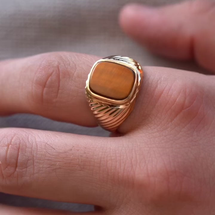 A sophisticated men's 14K gold ring with a 18mm width, worn on a model's hand. The polished yellow gold reflects light, adding elegance and confidence to any look.