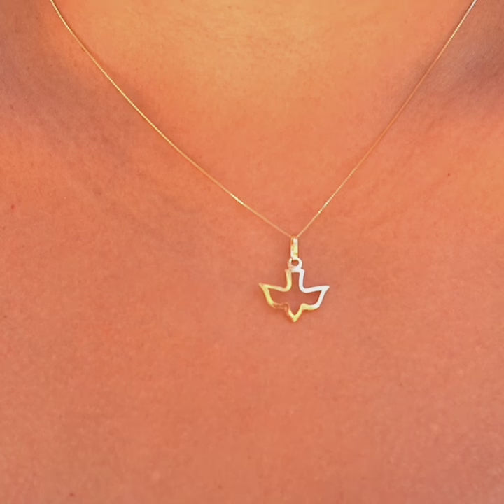 A model wearing the 14K solid gold Holy Spirit charm pendant on a delicate gold chain, showcasing the pendant's elegance and spiritual design as it rests gracefully on the model’s neck.