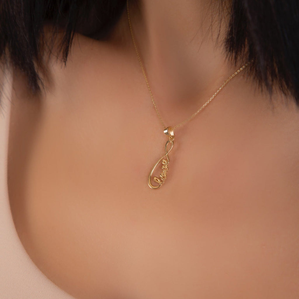 Model wearing 14K Solid Gold Love Infinity Pendant, right side angle capturing the charm's sleek and timeless design.
