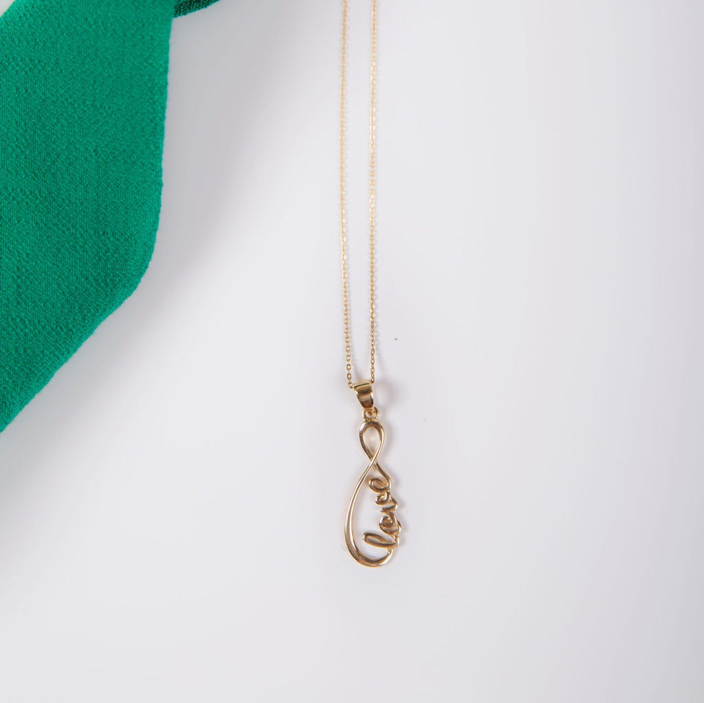 Close-up of 14K Solid Gold Love Infinity Pendant on a chain, showcasing intricate infinity design with the word 'Love' in fine detail.