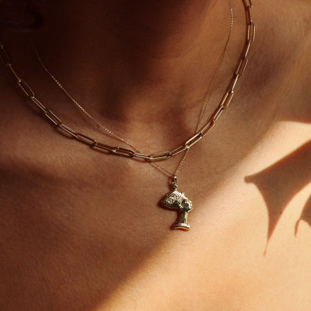 14K Real Gold Nefertiti Charm worn by a model, showcasing the elegant profile and intricate details of the Egyptian queen pendant.