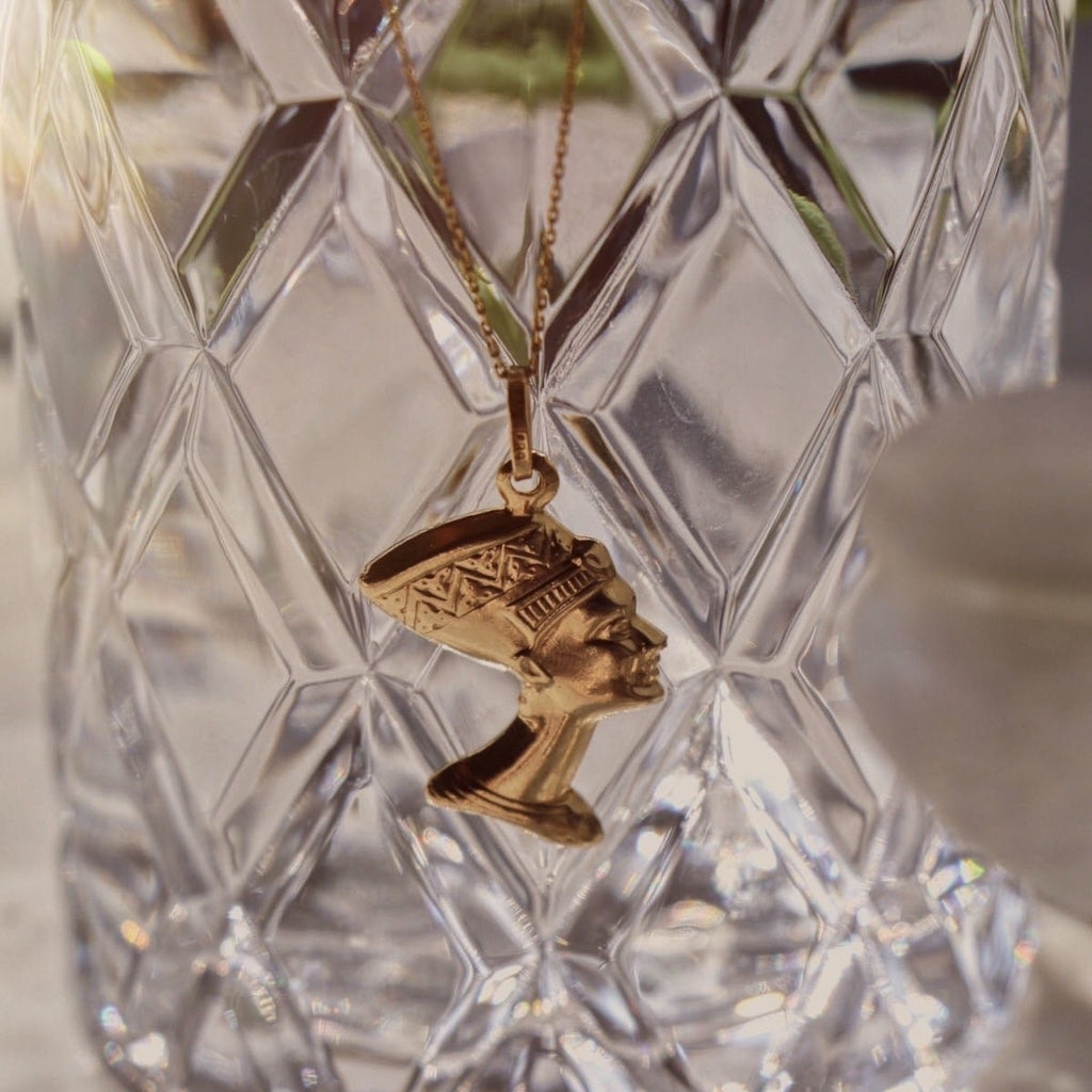 14K Real Gold Nefertiti Charm hanging on a chain, showcasing its detailed design and polished finish as it dangles elegantly.