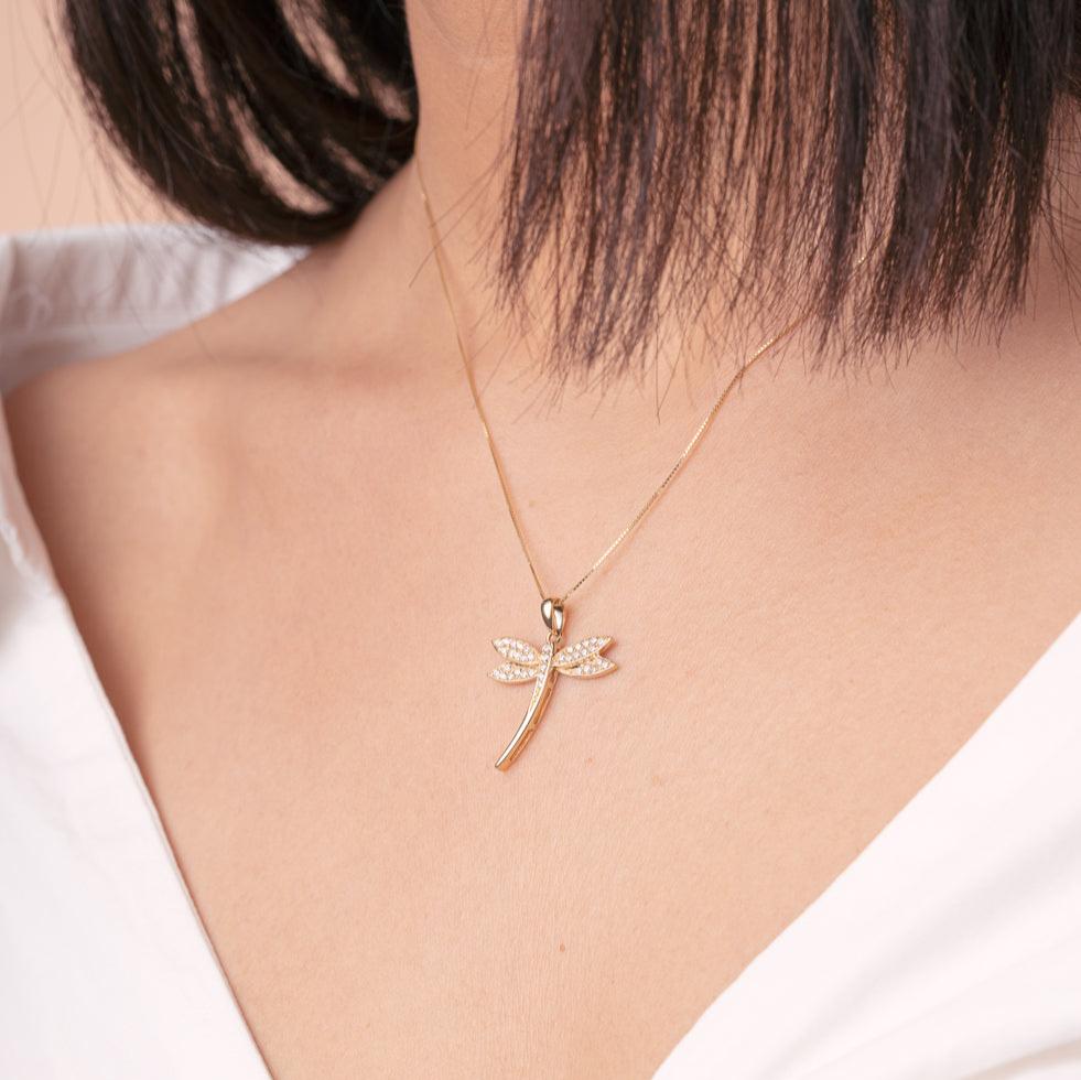 Model wearing 14K Gold Dragonfly Pendant with Cubic Zirconia, side profile view.