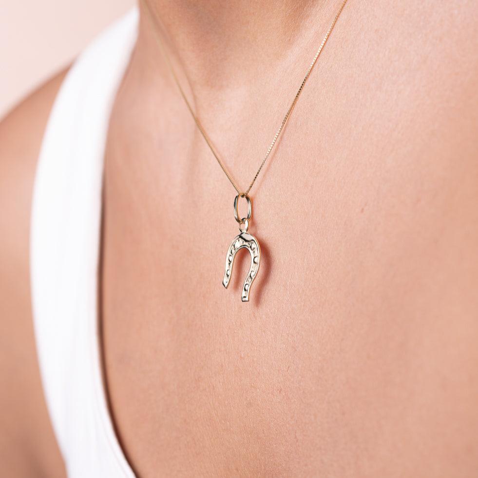 14K Solid Gold Horseshoe Charm worn by a model, captured from the right angle, highlighting the charm's polished finish and symbolic design.