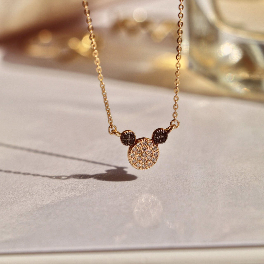 14K Solid Gold Mouse Necklace hanging elegantly, highlighting its intricate mouse pendant and polished yellow gold chain.