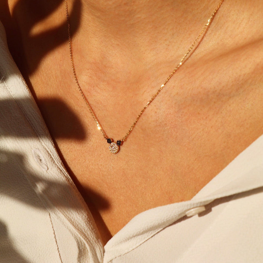 Model wearing the 14K Solid Gold Mouse Necklace, showcasing its dainty mouse pendant and elegant yellow gold chain with an adjustable 17+1 inch length.