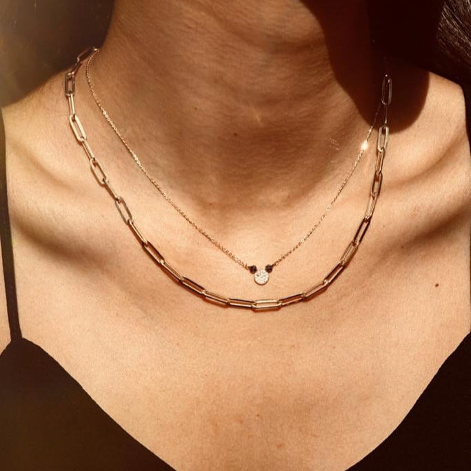 Model wearing the 14K Solid Gold Mouse Necklace layered with other necklaces, showcasing its dainty mouse pendant and how it complements a stylish layered jewelry look.