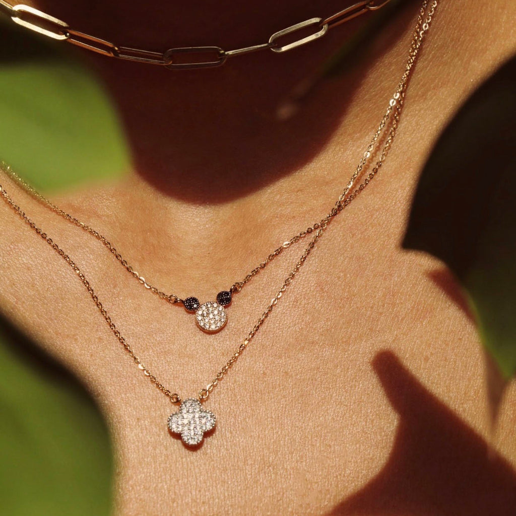 Model wearing the 14K Solid Gold Mouse Necklace layered with other necklaces, showcasing its dainty mouse pendant and how it complements a stylish layered jewelry look.