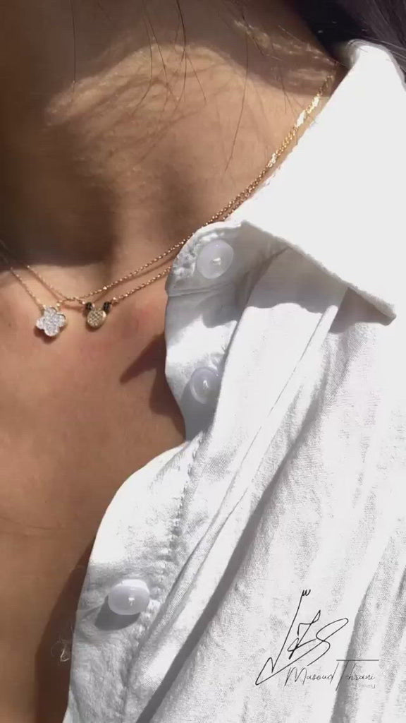 Video of a model wearing the 14K Solid Gold Mouse Necklace, showcasing the dainty mouse pendant, polished yellow gold chain, and adjustable length from various angles.