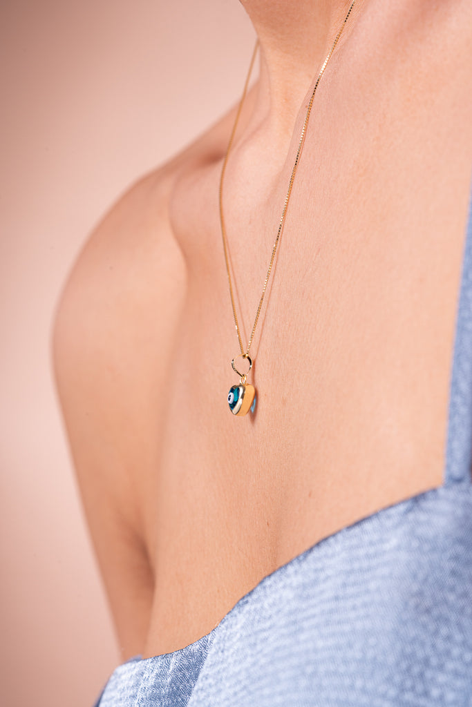 Graceful Side View - Our Model Showcasing the Blue Evil Eye Heart 14k Real Gold Charm, an Elegant Symbol of Protection.