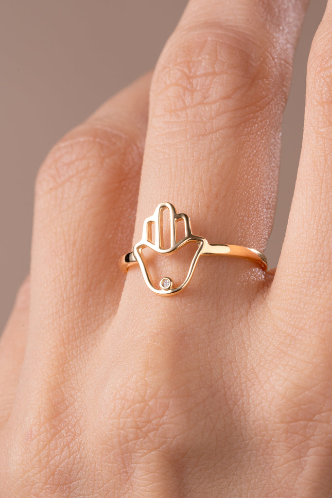 Hamsa Ring on Model hand this ring is a hamsa shaped ring with a cubic zirconia stone on the palm.